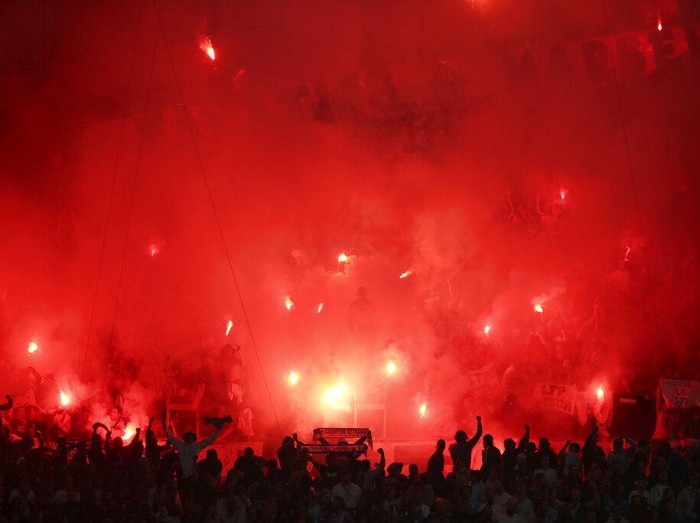 Marseille fans hold flares as they fill the stands during the French League One soccer match between Marseille and Paris Saint-Germain in Marseille, France, Sunday, Oct. 24, 2021. (AP Photo/Daniel Cole)