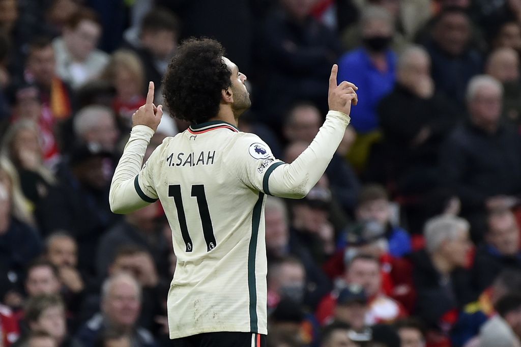 Liverpool's Mohamed Salah celebrates after scoring his side's third goal during the English Premier League soccer match between Manchester United and Liverpool at Old Trafford in Manchester, England, Sunday, Oct. 24, 2021. (AP Photo/Rui Vieira)
