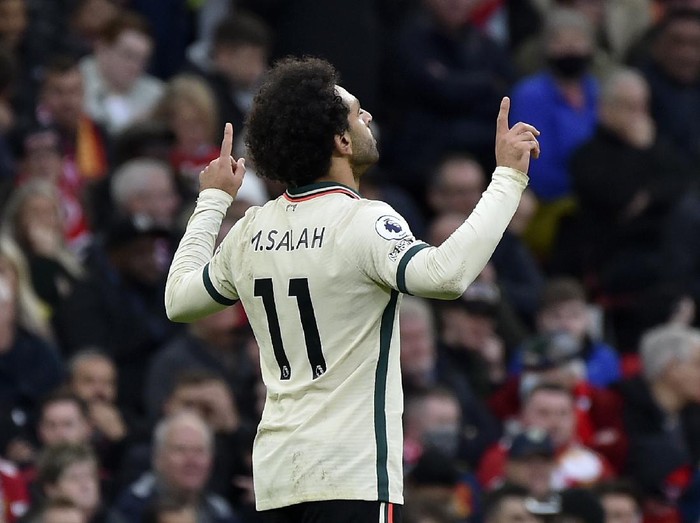 Liverpool's Mohamed Salah celebrates after scoring his side's third goal during the English Premier League soccer match between Manchester United and Liverpool at Old Trafford in Manchester, England, Sunday, Oct. 24, 2021. (AP Photo/Rui Vieira)