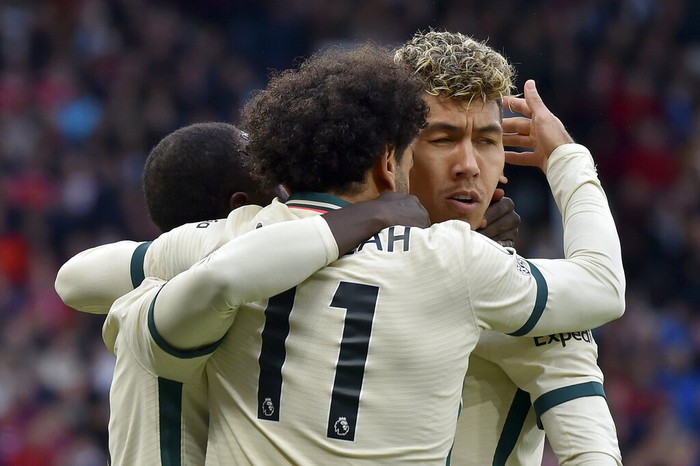 Liverpools Roberto Firmino runs with the ball away from Manchester Uniteds Fred, left, during the English Premier League soccer match between Manchester United and Liverpool at Old Trafford in Manchester, England, Sunday, Oct. 24, 2021. (AP Photo/Rui Vieira)