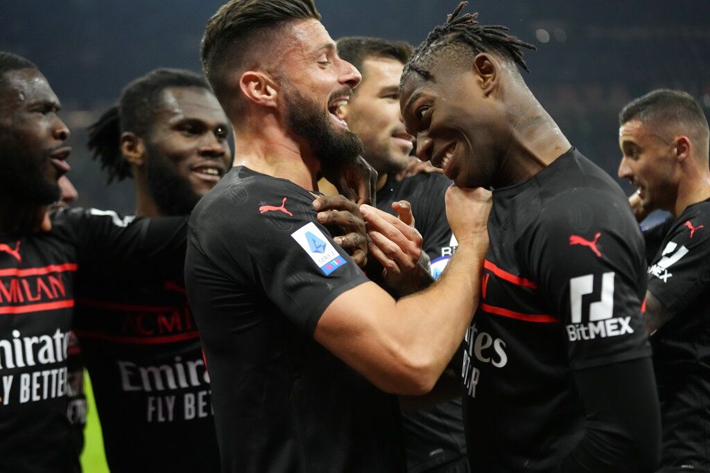 AC Milan's Olivier Giroud, left, celebrates with his teammates after scoring his side's opening goal during a Serie A soccer match between AC Milan and Torino, at the San Siro stadium, in Milan, Italy, Tuesday, Oct. 26, 2021. (AP Photo/Luca Bruno)