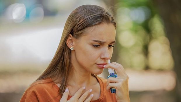 Sick Woman Holding Nasal Spray