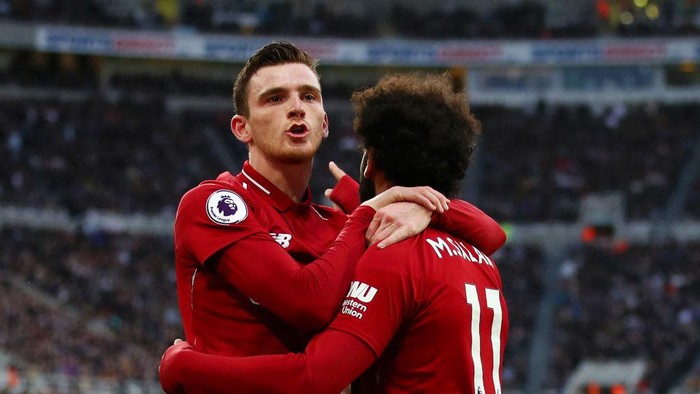 NEWCASTLE UPON TYNE, ENGLAND - MAY 04: Mohamed Salah of Liverpool celebrates with teammate Andy Robertson after scoring his teams second goal during the Premier League match between Newcastle United and Liverpool FC at St. James Park on May 04, 2019 in Newcastle upon Tyne, United Kingdom. (Photo by Clive Brunskill/Getty Images)