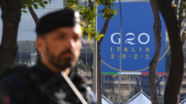 A Carabinieri police officer stands guard outside the convention center 