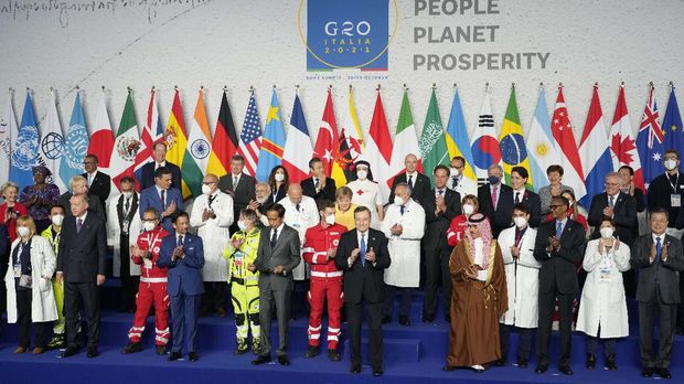 Medical personnel and world leaders pose for a group photo at the La Nuvola conference center for the G20 summit in Rome, Saturday, Oct. 30, 2021. The two-day Group of 20 summit is the first in-person gathering of leaders of the world's biggest economies since the COVID-19 pandemic started. (AP Photo/Gregorio Borgia)