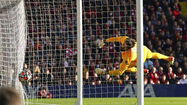 Liverpool's goalkeeper Alisson dives but fails to stop Brighton's Enock Mwepu goal during the English Premier League soccer match between Liverpool and Brighton and Hove Albion at Anfield Stadium, Liverpool, England, Saturday, Oct. 30, 2021. (AP Photo/Jon Super)