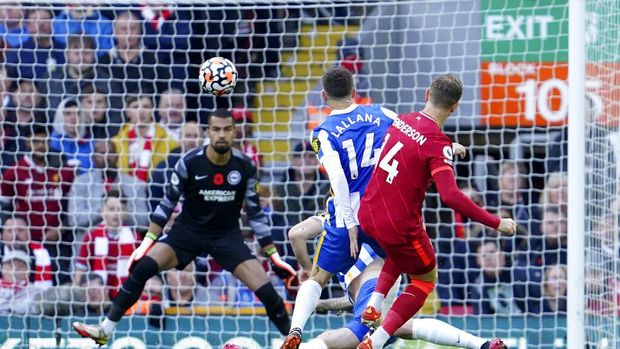 Liverpool's Jordan Henderson, right, scores the opening goal during the English Premier League soccer match between Liverpool and Brighton and Hove Albion at Anfield Stadium, Liverpool, England, Saturday, Oct. 30, 2021. (AP Photo/Jon Super)