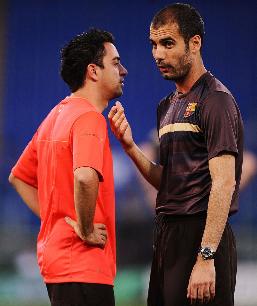 ROME - MAY 26:  Josep Guardiola coach of Barcelona speaks to Xavi during the Barcelona training session prior to UEFA Champions League Final versus Manchester United at the Stadio Olimpico on May 26, 2009 in Rome, Italy.  (Photo by Jasper Juinen/Getty Images)