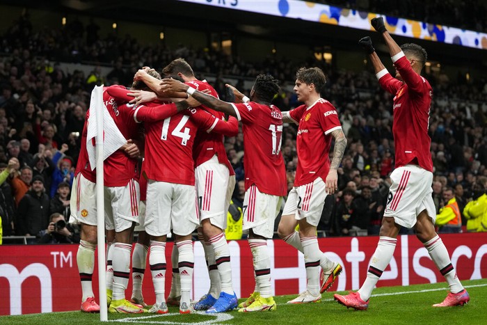 Manchester Uniteds Marcus Rashford, left, celebrates after scoring his sides third goal during the English Premier League soccer match between Tottenham Hotspur and Manchester United at the Tottenham Hotspur Stadium in London, Saturday, Oct. 30, 2021. (AP Photo/Frank Augstein)