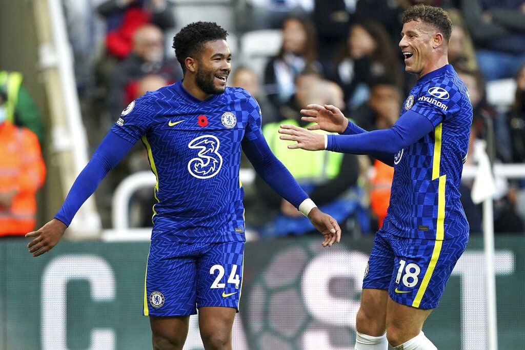 Chelsea's Reece James, left, celebrates scoring with Ross Barkley during the English Premier League soccer match between Newcastle United and Chelsea at St. James' Park, Newcastle, England, Saturday Oct. 30, 2021. (Owen Humphreys/PA via AP)