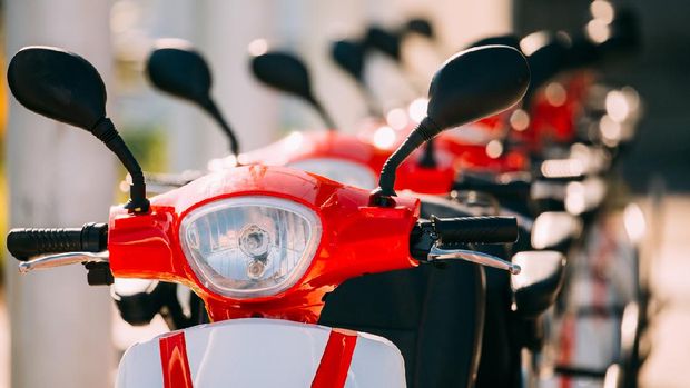 Close Up Of Handlebars Of Many Electric Motorbikes, Motorcycles Scooters Parked In Row In City Street.