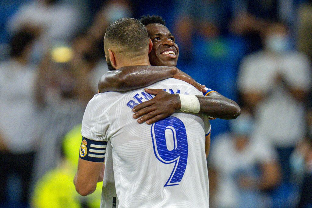 Real Madrid's Karim Benzema celebrates with his teammate Real Madrid's Vinicius Junior after scoring a penalty kick during the Spanish La Liga soccer match between Real Madrid and Celta de Vigo at the Bernabeu stadium in Madrid, Spain, Sunday, Sept. 12, 2021. (AP Photo/Manu Fernandez)