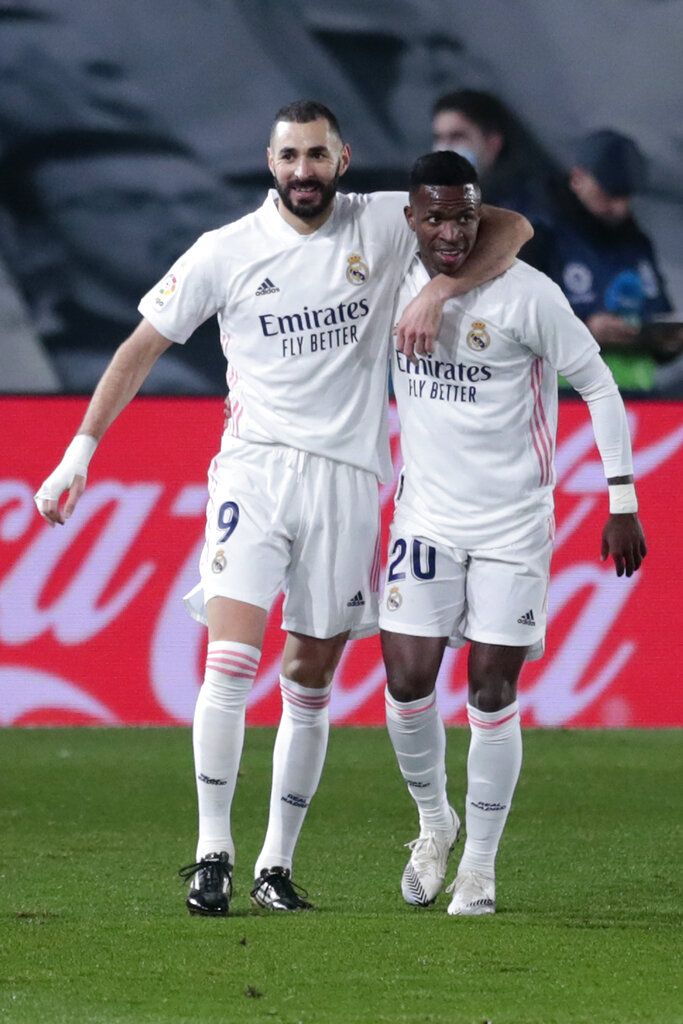 Real Madrid's Karim Benzema celebrates with his teammate Real Madrid's Vinicius Junior after scoring a penalty kick during the Spanish La Liga soccer match between Real Madrid and Celta de Vigo at the Bernabeu stadium in Madrid, Spain, Sunday, Sept. 12, 2021. (AP Photo/Manu Fernandez)