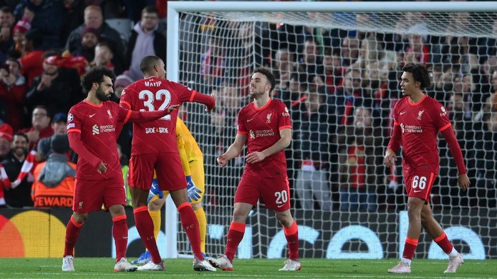 LIVERPOOL, ENGLAND - NOVEMBER 03: Diogo Jota of Liverpool (3L) celebrates with teammates Mohamed Salah, Joel Matip and Trent Alexander-Arnold after scoring their teams first goal during the UEFA Champions League group B match between Liverpool FC and Atletico Madrid at Anfield on November 03, 2021 in Liverpool, England. (Photo by Laurence Griffiths/Getty Images)