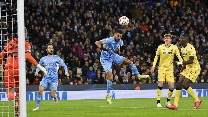 Manchester City's Riyad Mahrez, center, scores his side's second goal during the Champions League Group A soccer match between Manchester City and Club Brugge at the Etihad stadium, in Manchester, England, Wednesday Nov. 3, 2021. (AP Photo/Rui Vieira)