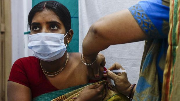 A health worker administers a dose of Covaxin COVID-19 vaccine at a health center in Garia , South 24 Pargana district, India, Thursday, Oct. 21, 2021. India has administered 1 billion doses of COVID-19 vaccine, passing a milestone for the South Asian country where the delta variant fueled its first crushing surge this year. (AP Photo/Bikas Das)