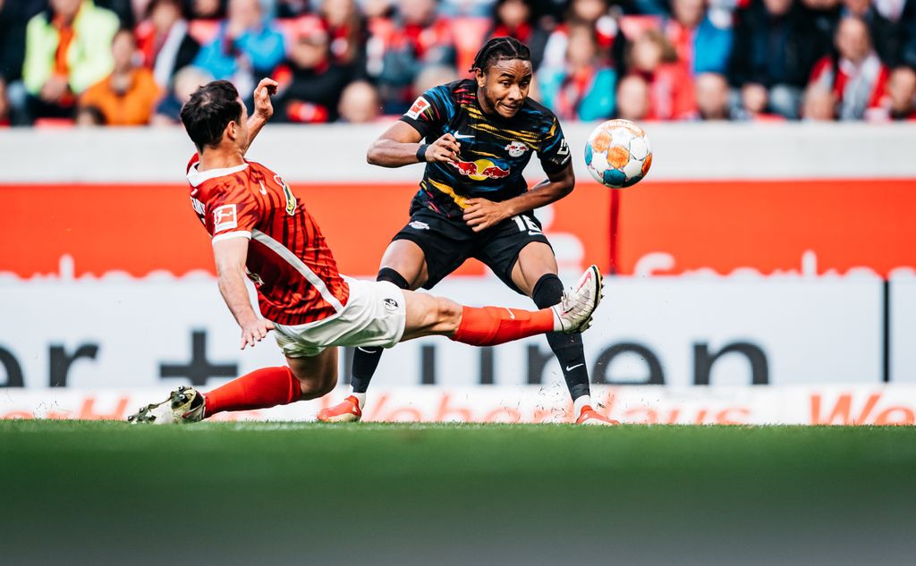 Christopher Nkunku FREIBURG IM BREISGAU, GERMANY - OCTOBER 16: Christopher Nkunku of Leipzig in action against Nicolas Hfler of Freiburg during the Bundesliga match between Sport-Club Freiburg and RB Leipzig at Europa-Park-Stadion on October 16, 2021 in Freiburg im Breisgau, Germany. (Photo by Alexander Scheuber/Bundesliga/Bundesliga Collection via Getty Images)