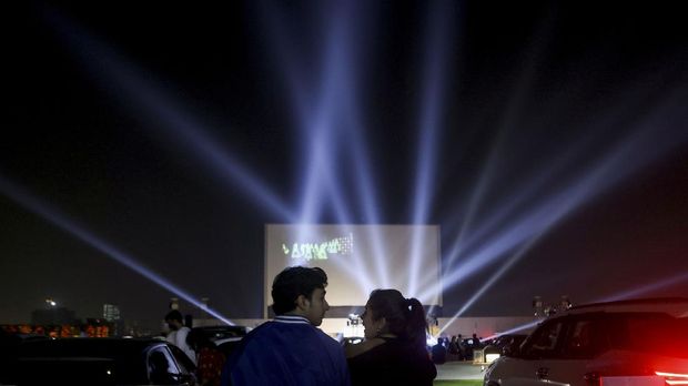 People wait for the start of a premiere movie screening at India's first open air rooftop drive-in cinema in Mumbai, India, November 5, 2021. REUTERS/Francis Mascarenhas     TPX IMAGES OF THE DAY