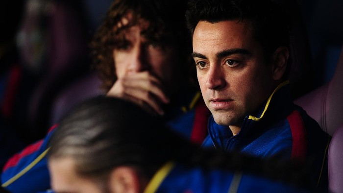 MALAGA, SPAIN - JANUARY 22:  Xavi Hernandez of FC Barcelona looks on from the bench prior to the La Liga match between Malaga CF and FC Barcelona at La Rosaleda Stadium on January 22, 2012 in Malaga, Spain. FC Barcelona won 4-1.  (Photo by David Ramos/Getty Images)