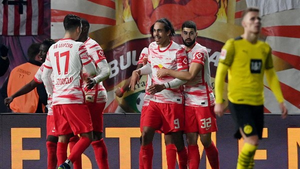 LEIPZIG, GERMANY - NOVEMBER 06: Yussuf Poulsen of RB Leipzig celebrates scoring his sides second goal with team mates during the Bundesliga match between RB Leipzig and Borussia Dortmund at Red Bull Arena on November 06, 2021 in Leipzig, Germany. (Photo by Stuart Franklin/Getty Images)