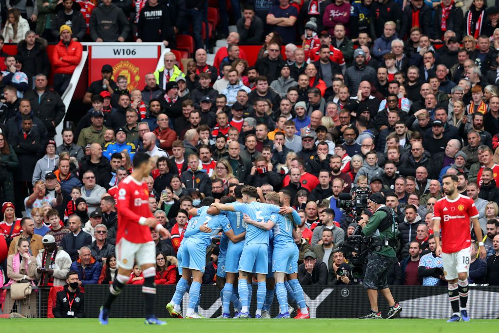 MANCHESTER, ENGLAND - NOVEMBER 06: Manchester City players celebrate after an own goal by Eric Bailly of Manchester United (not pictured) during the Premier League match between Manchester United and Manchester City at Old Trafford on November 06, 2021 in Manchester, England. (Photo by Clive Brunskill/Getty Images)