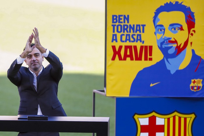 Xavi FC Barcelona's new signing coach Xavi Hernandez waves to the crowd during his official presentation at the Camp Nou stadium in Barcelona, Spain, Monday, Nov. 8, 2021. Xavi, who thrived in Barcelona's midfield alongside Messi and Andres Iniesta, was officially introduced as coach on the field of the Camp Nou with a reception usually only offered to top players. (AP Photo/Joan Monfort)