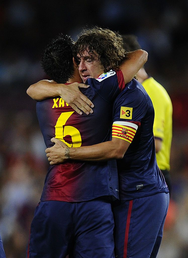BARCELONA, SPAIN - AUGUST 19:  Carles Puyol of FC Barcelona (R) celebrates with his teammates Xavi Hernandez of FC Barcelona after scoring the opening goal during the La Liga match between FC Barcelona and Real Sociedad de Futbol at Camp Nou on August 19, 2012 in Barcelona, Spain.  (Photo by David Ramos/Getty Images)