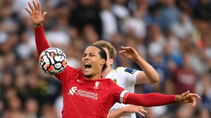 LEEDS, ENGLAND - SEPTEMBER 12: Virgil van Dijk of Liverpool is fouled by Patrick Bamford of Leeds United during the Premier League match between Leeds United and Liverpool at Elland Road on September 12, 2021 in Leeds, England. (Photo by Laurence Griffiths/Getty Images)