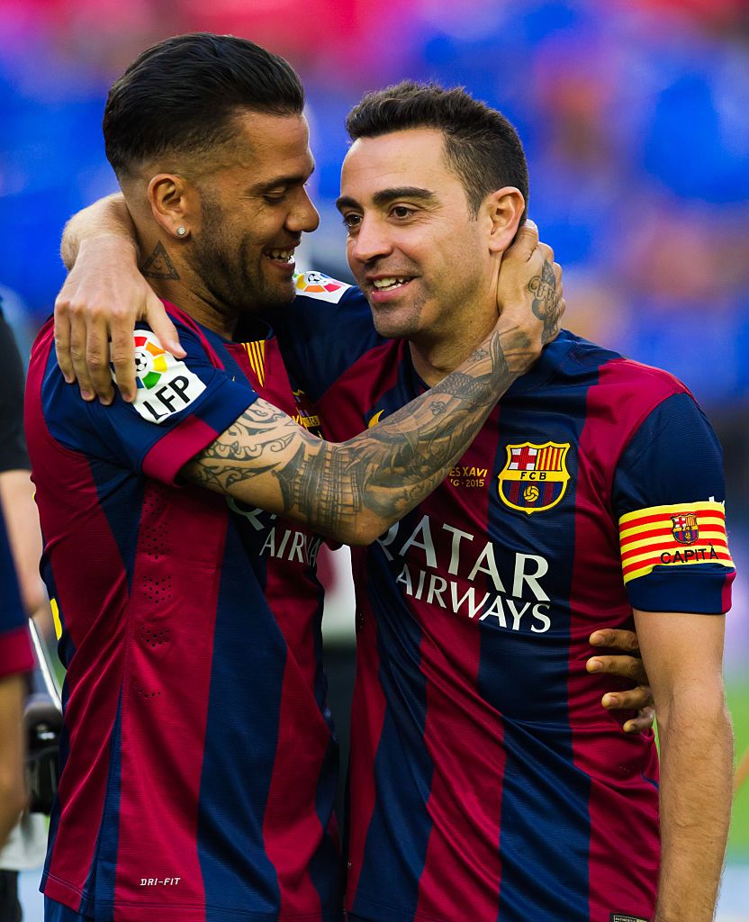 BARCELONA, SPAIN - MAY 23: Dani Alves (L) of FC Barcelona embraces his teammate Xavi Hernandez after the La Liga match between FC Barcelona and RC Deportivo La Coruna at Camp Nou on May 23, 2015 in Barcelona, Spain. (Photo by Alex Caparros/Getty Images)