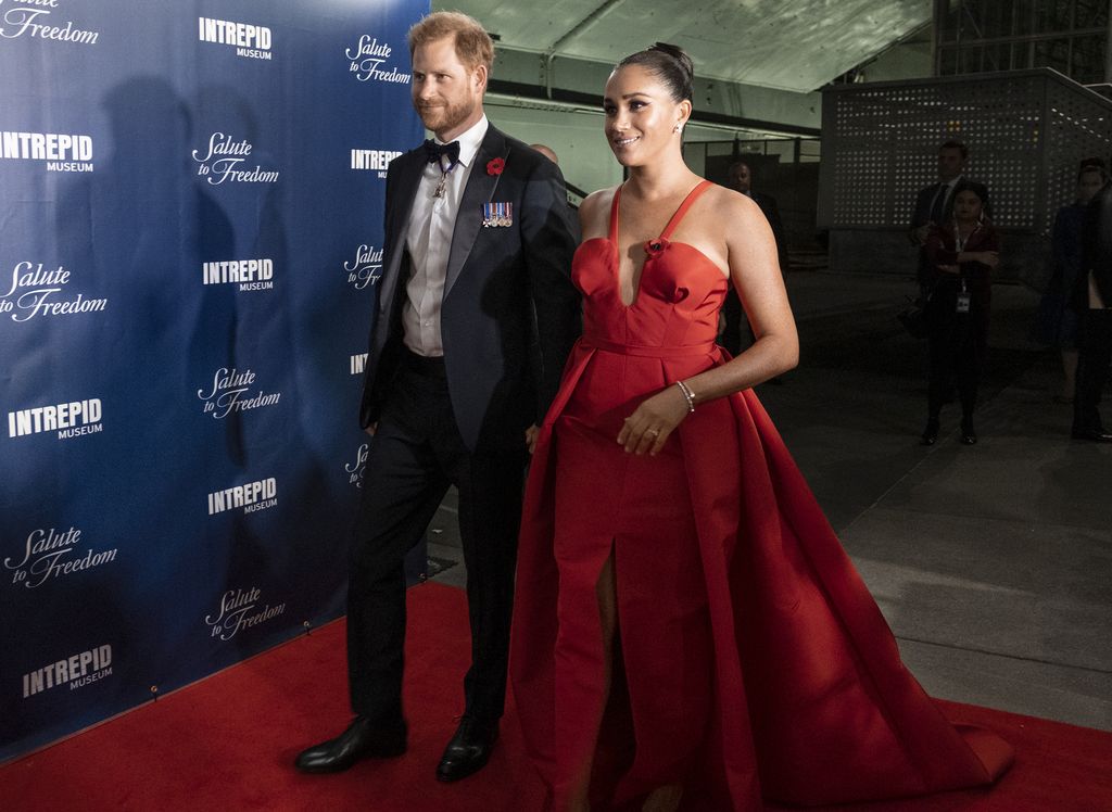 Prince Harry and Meghan Markle, Duke and Duchess of Sussex, greet Stephen Rudinski, right, a Valor Award recipient, and others, as they arrive at the Intrepid Sea, Air & Space Museum for the Salute to Freedom Gala Wednesday, Nov. 10, 2021, in New York. The Duke of Sussex will also present the inaugural Intrepid Valor Award to five service members, veterans and their military families. Valor Award recipients Barbara Block, center left, and Master Sgt. Kyle Hines, center right, look on.  (AP Photo/Craig Ruttle)