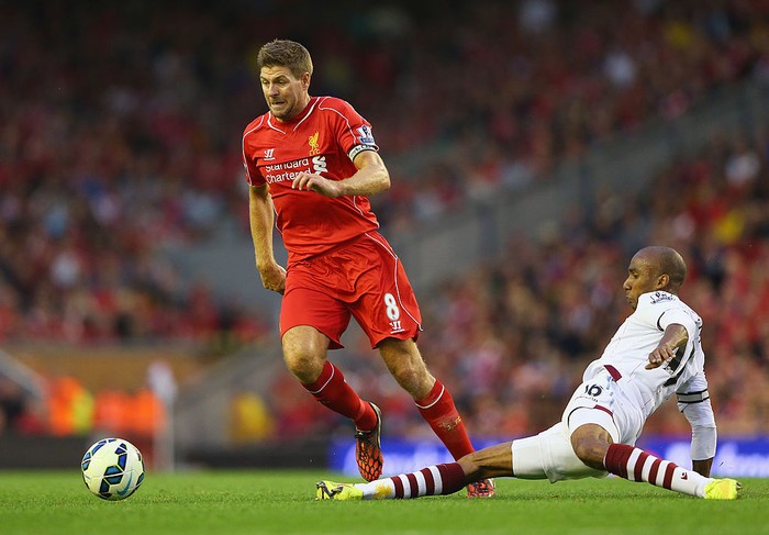 LIVERPOOL, ENGLAND - SEPTEMBER 13: Steven Gerrard of Liverpool is tackled by Fabian Delph of Aston Villa during the Barclays Premier League match between Liverpool and Aston Villa at Anfield on September 13, 2014 in Liverpool, England.  (Photo by Alex Livesey/Getty Images)