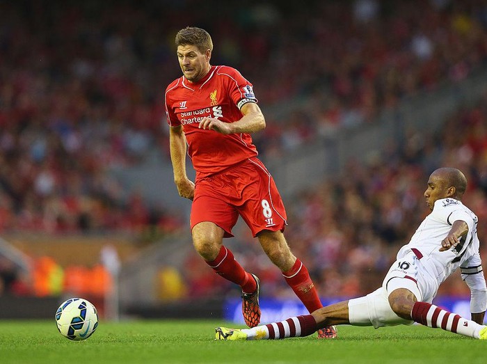 LIVERPOOL, ENGLAND - SEPTEMBER 13: Steven Gerrard of Liverpool is tackled by Fabian Delph of Aston Villa during the Barclays Premier League match between Liverpool and Aston Villa at Anfield on September 13, 2014 in Liverpool, England.  (Photo by Alex Livesey/Getty Images)