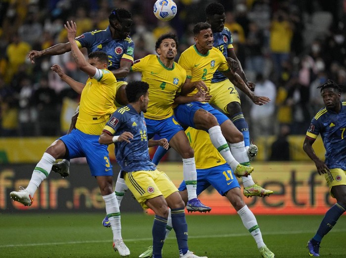 Brazils Marquinhos, center, and Colombias Jefferson Lerma head for the ball during a qualifying soccer match for the FIFA World Cup Qatar 2022 at Neo Quimica Arena stadium in Sao Paulo, Brazil, Thursday, Nov.11, 2021. (AP Photo/Andre Penner)
