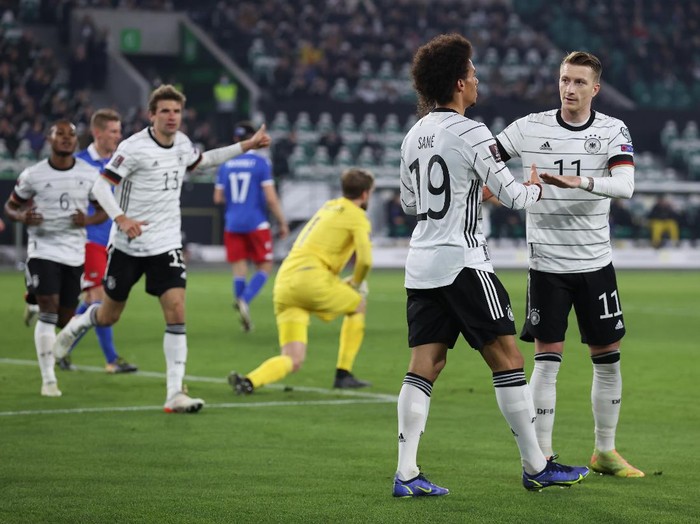WOLFSBURG, GERMANY - NOVEMBER 11: Leroy Sane of Germany celebrates his teams third goal with teammate Marco Reus during the 2022 FIFA World Cup Qualifier match between Germany and Liechtenstein at Volkswagen Arena on November 11, 2021 in Wolfsburg, Lower Saxony. (Photo by Alex Grimm/Getty Images)