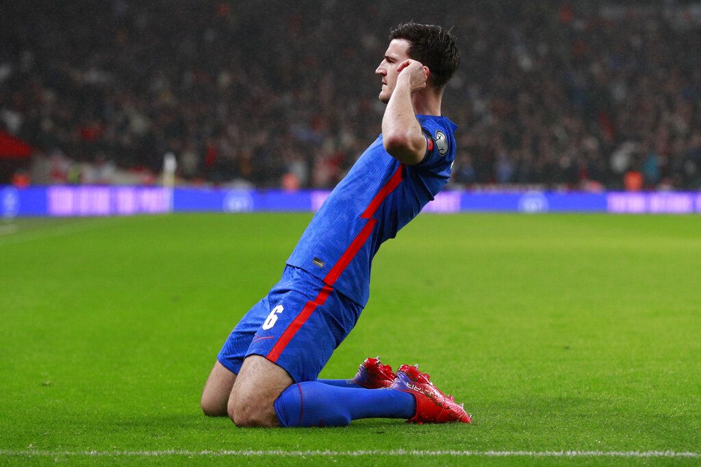 England's Harry Maguire celebrates after he scores his side's first goal during the World Cup 2022 group I qualifying soccer match between England and Albania at Wembley stadium in London, Friday, Nov. 12, 2021. (AP Photo/Ian Walton)