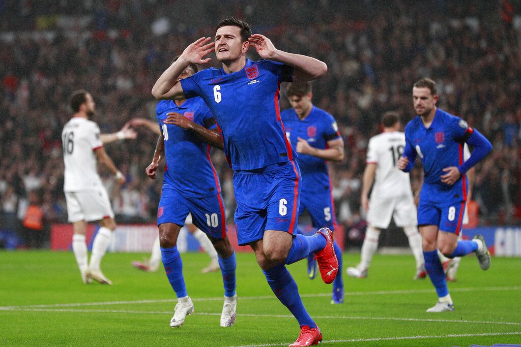 England's Harry Maguire celebrates after he scores his side's first goal during the World Cup 2022 group I qualifying soccer match between England and Albania at Wembley stadium in London, Friday, Nov. 12, 2021. (AP Photo/Ian Walton)