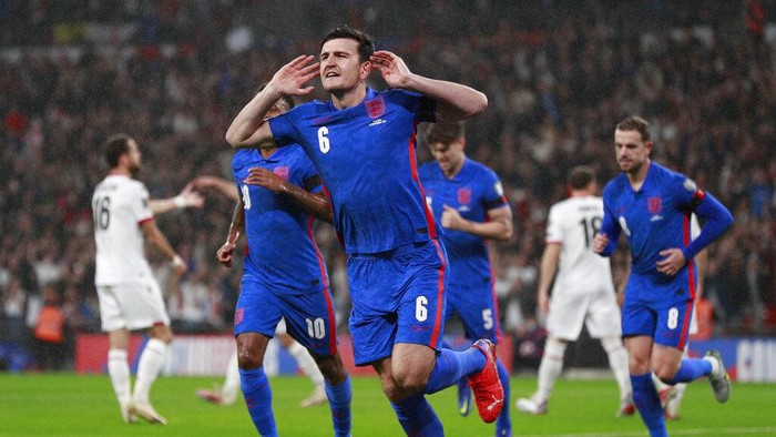 Englands Harry Maguire celebrates after he scores his sides first goal during the World Cup 2022 group I qualifying soccer match between England and Albania at Wembley stadium in London, Friday, Nov. 12, 2021. (AP Photo/Ian Walton)