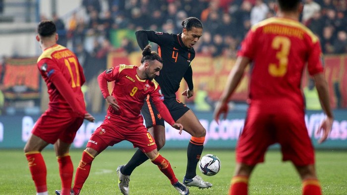PODGORICA, MONTENEGRO - NOVEMBER 13: Virgil van Dijk of Netherlands and Marko Jankovic of Montenegro during the 2022 FIFA World Cup Qualifier match between Montenegro and Netherlands at Gradski Stadion on November 13, 2021 in Podgorica, Montenegro. (Photo by Filip Filipovic/Getty Images)