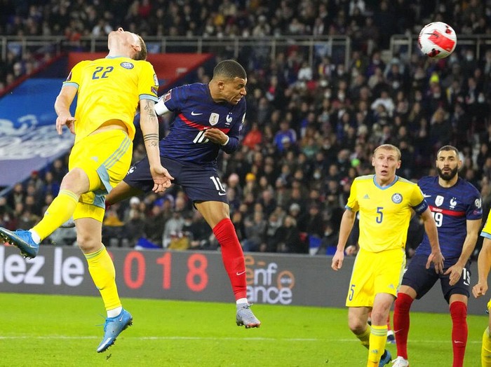 France's Kilian Mbappe, centre, scores his side's third goal during the World Cup 2022 group D qualifying soccer match between France and Kazakhstan at the Parc des Princes stadium in Paris, France, Saturday, Nov. 13, 2021. (AP Photo/Michel Euler)
