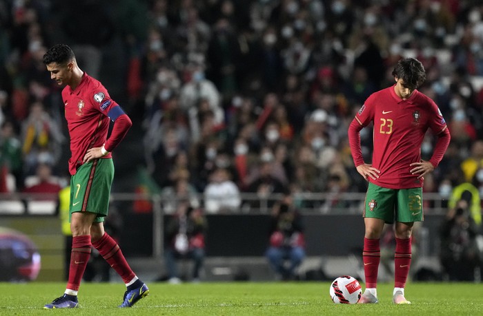 Portugals Cristiano Ronaldo, left, and Portugals Joao Felix react after Serbias Aleksandar Mitrovic scoring his sides second goal during the World Cup 2022 group A qualifying soccer match between Portugal and Serbia at the Luz stadium in Lisbon, Sunday, Nov 14, 2021. (AP Photo/Armando Franca)