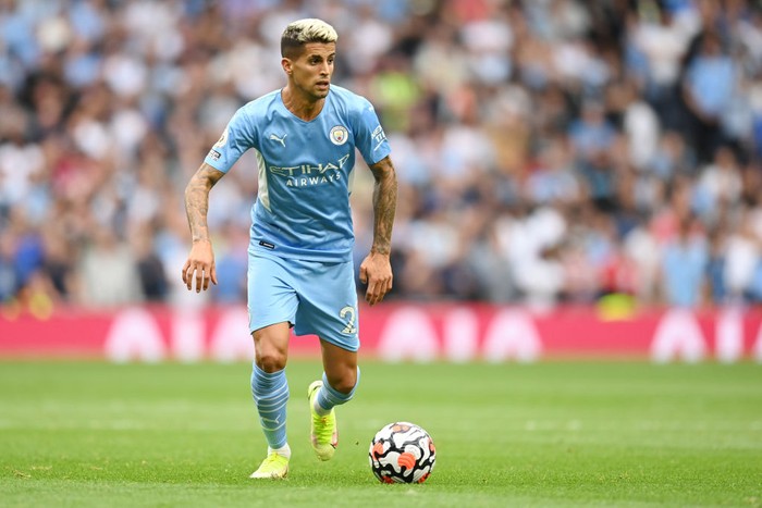 MANCHESTER, ENGLAND - AUGUST 21: Joao Cancelo of Manchester City controls the ball during the Premier League match between Manchester City and Norwich City at Etihad Stadium on August 21, 2021 in Manchester, England. (Photo by Shaun Botterill/Getty Images )