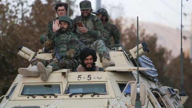 Members of Taliban sit on a military vehicle during Taliban military parade in Kabul, Afghanistan November 14, 2021. REUTERS/Ali Khara NO RESALES. NO ARCHIVES