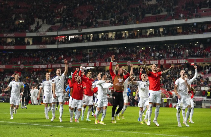 Serbias Aleksandar Mitrovic celebrates with teammates after scoring his sides second goal during the World Cup 2022 group A qualifying soccer match between Portugal and Serbia at the Luz stadium in Lisbon, Sunday, Nov 14, 2021. (AP Photo/Armando Franca)