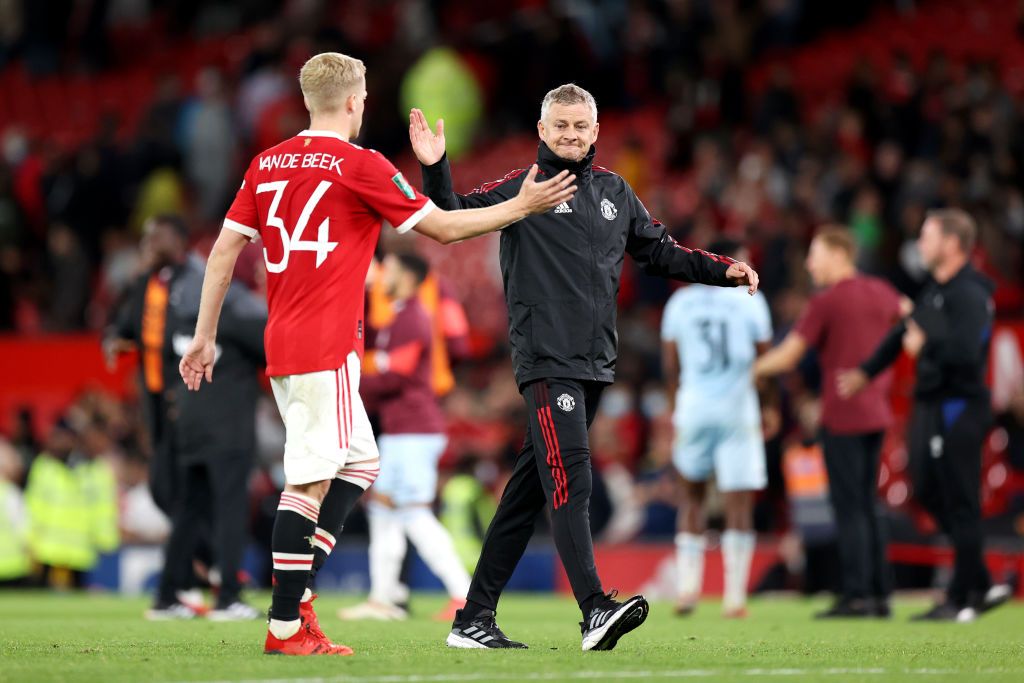 MANCHESTER, ENGLAND - SEPTEMBER 22: Ole Gunnar Solskjaer embraces Donny van de Beek of Manchester United after the Carabao Cup Third Round match between Manchester United and West Ham United at Old Trafford on September 22, 2021 in Manchester, England. (Photo by Alex Pantling/Getty Images)