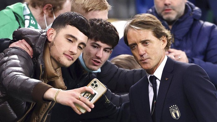 Italy manager Roberto Mancini poses for a picture with fans following their World Cup 2022 group C qualifying soccer match between Northern Ireland and Italy at Windsor Park stadium in Belfast, Northern Ireland, Monday, Nov. 15, 2021. (Liam McBurney/PA via AP)