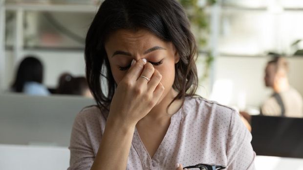 Tired mixed race Black business woman, office employee touching, rubbing nose bridge with closed irritable eyes, bad strain blurry vision, eyesight problems, headache, feeling stress, fatigue
