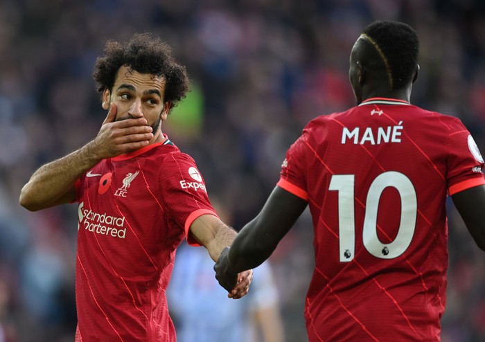 LIVERPOOL, ENGLAND - OCTOBER 30:  Mohamed Salah of Liverpool talks with team mate Sadio Mane during the Premier League match between Liverpool and Brighton & Hove Albion at Anfield on October 30, 2021 in Liverpool, England. (Photo by Shaun Botterill/Getty Images)