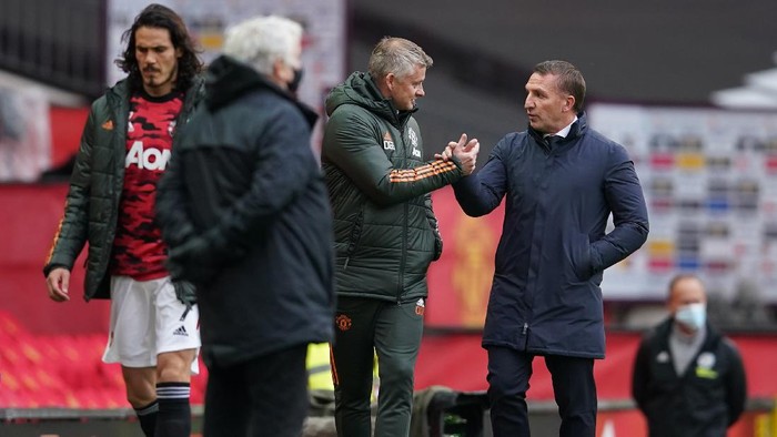 MANCHESTER, ENGLAND - MAY 11: Ole Gunnar Solskjaer, Manager of Manchester United interacts with Brendan Rodgers (R), Manager of Leicester City prior to the Premier League match between Manchester United and Leicester City at Old Trafford on May 11, 2021 in Manchester, England. Sporting stadiums around the UK remain under strict restrictions due to the Coronavirus Pandemic as Government social distancing laws prohibit fans inside venues resulting in games being played behind closed doors.  (Photo by Dave Thompson - Pool/Getty Images)