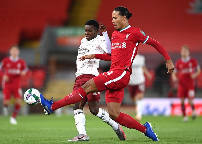 LIVERPOOL, ENGLAND - OCTOBER 01: Virgil van Dijk of Liverpool is challenged by Eddie Nketiah of Arsenal during the Carabao Cup fourth round match between Liverpool and Arsenal at Anfield on October 01, 2020 in Liverpool, England. Football Stadiums around United Kingdom remain empty due to the Coronavirus Pandemic as Government social distancing laws prohibit fans inside venues resulting in fixtures being played behind closed doors. (Photo by Laurence Griffiths/Getty Images)