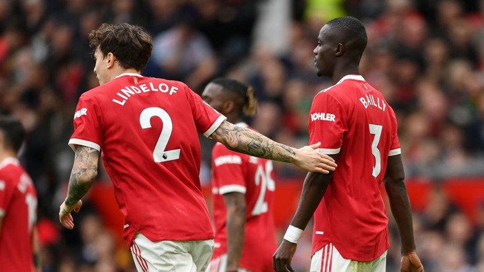 MANCHESTER, ENGLAND - NOVEMBER 06: Victor Lindeloef embraces Eric Bailly of Manchester United after he scored an own goal during the Premier League match between Manchester United and Manchester City at Old Trafford on November 06, 2021 in Manchester, England. (Photo by Michael Regan/Getty Images)